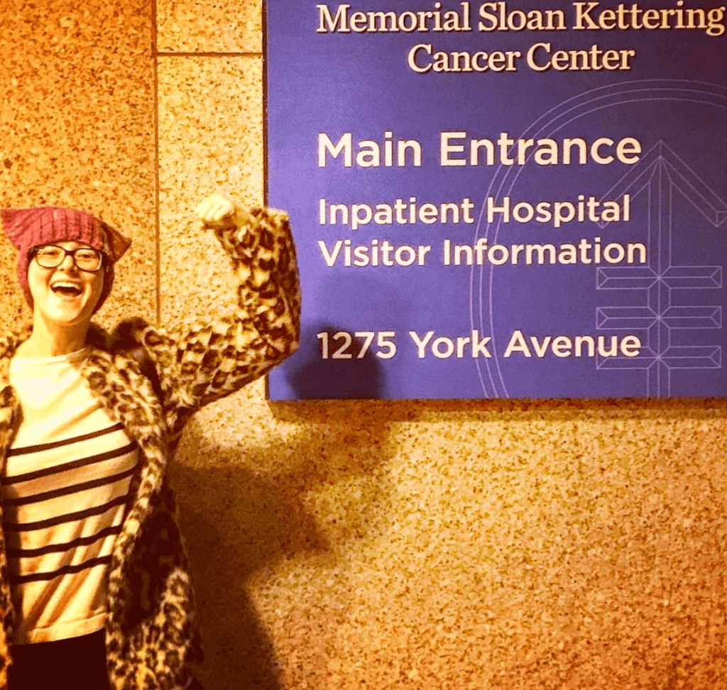 woman in front of sloan cancer center sign