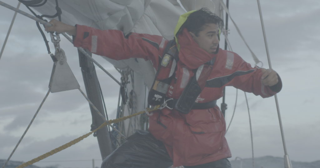 Emmanuel S. on a boat in the rain