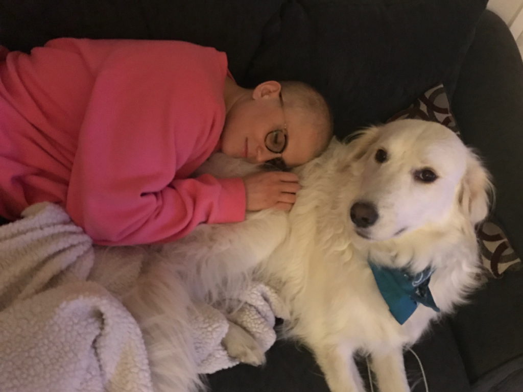 Kelsey R. laying on couch with dog