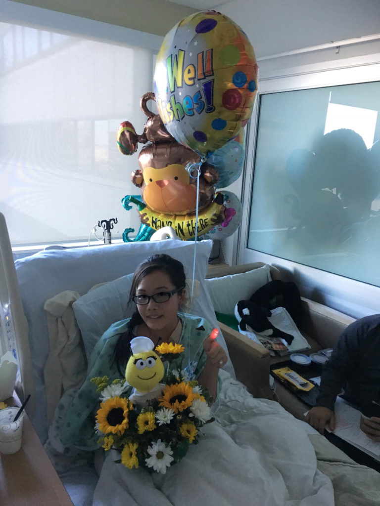 Stephanie C. holding balloon and flowers