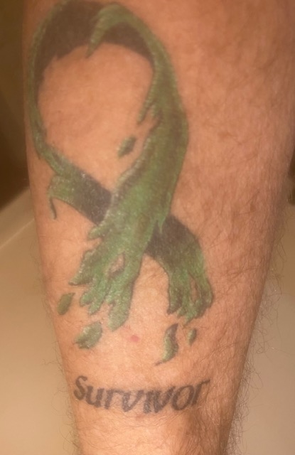 Kris W. cancer survivor ribbon tattoo