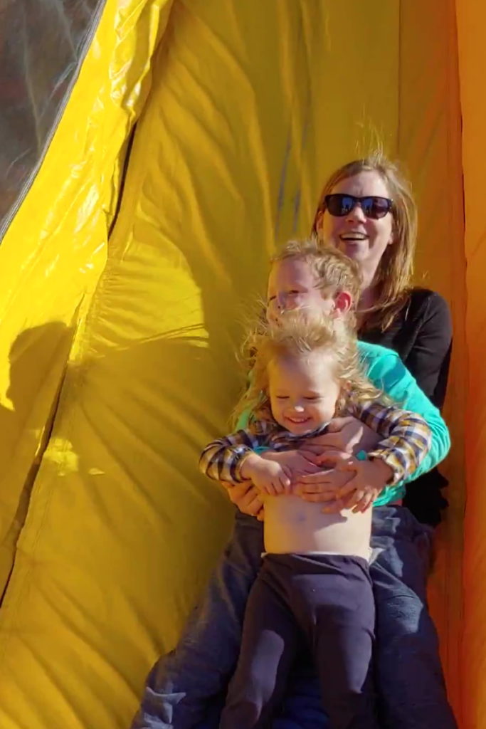 Manda M. and kids go down slide