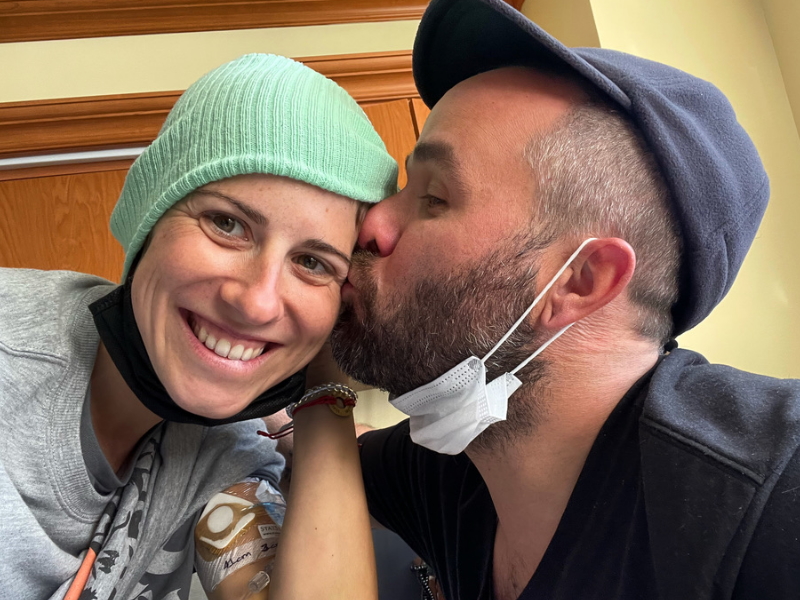 Anna T. and husband Joe in beanie and cap kiss