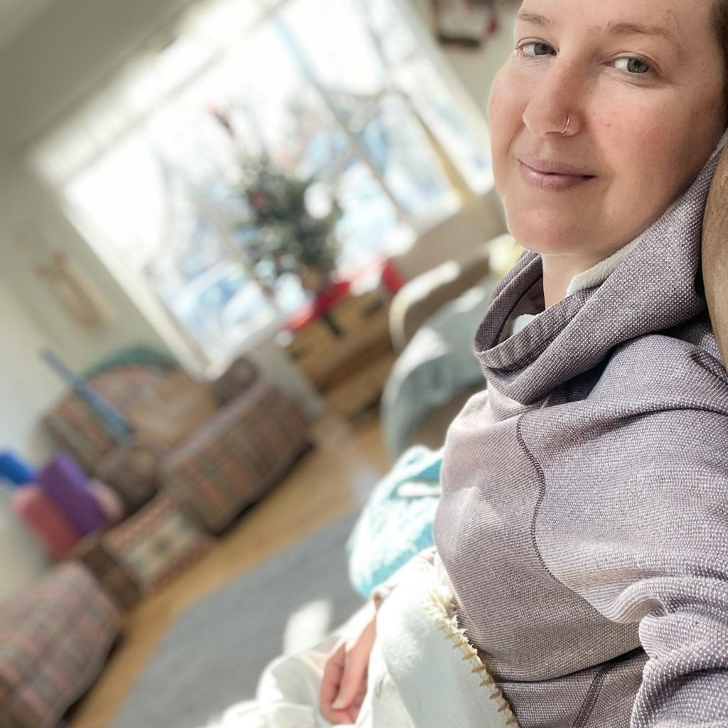 Bethany W. seated on couch