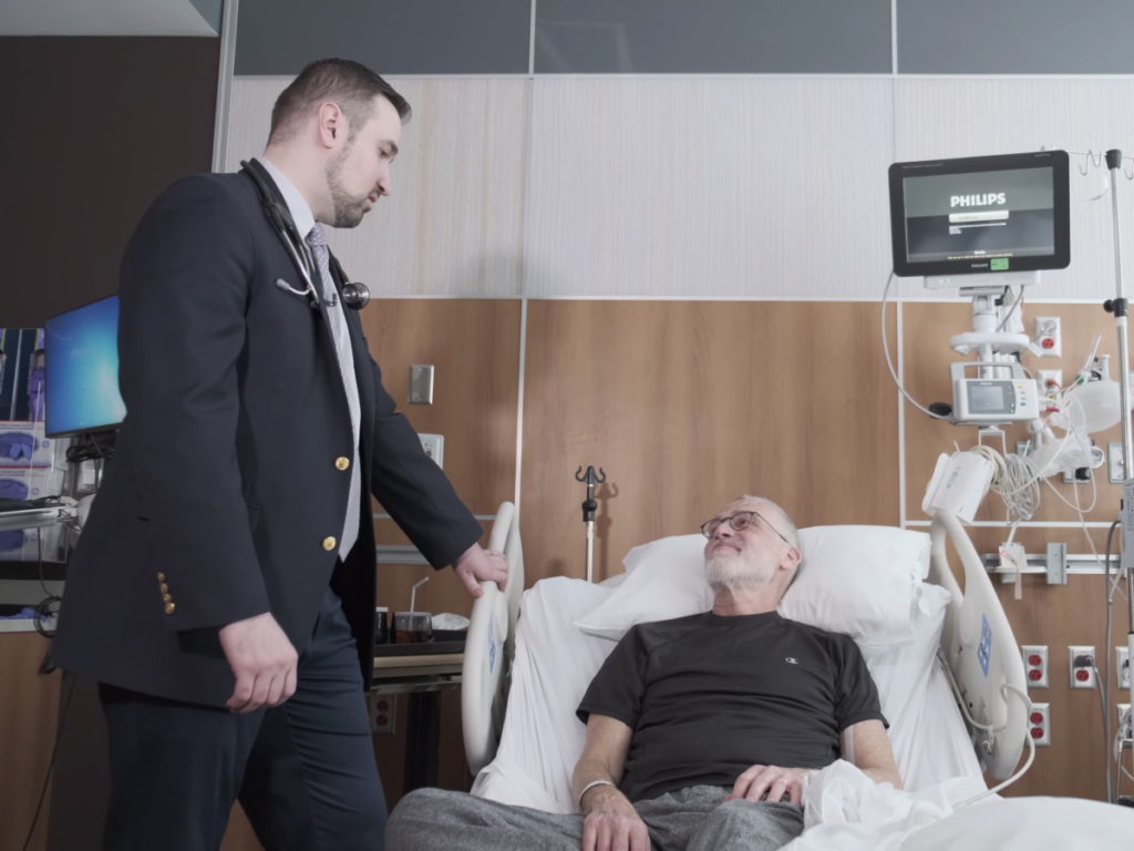 Dr. Muhamed Baljević with patient in bed