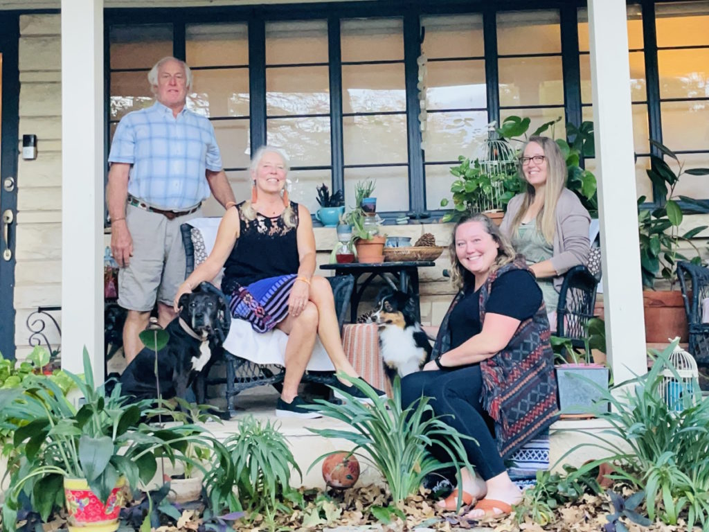 Vickie D. and partner Mitch with daughters outside house