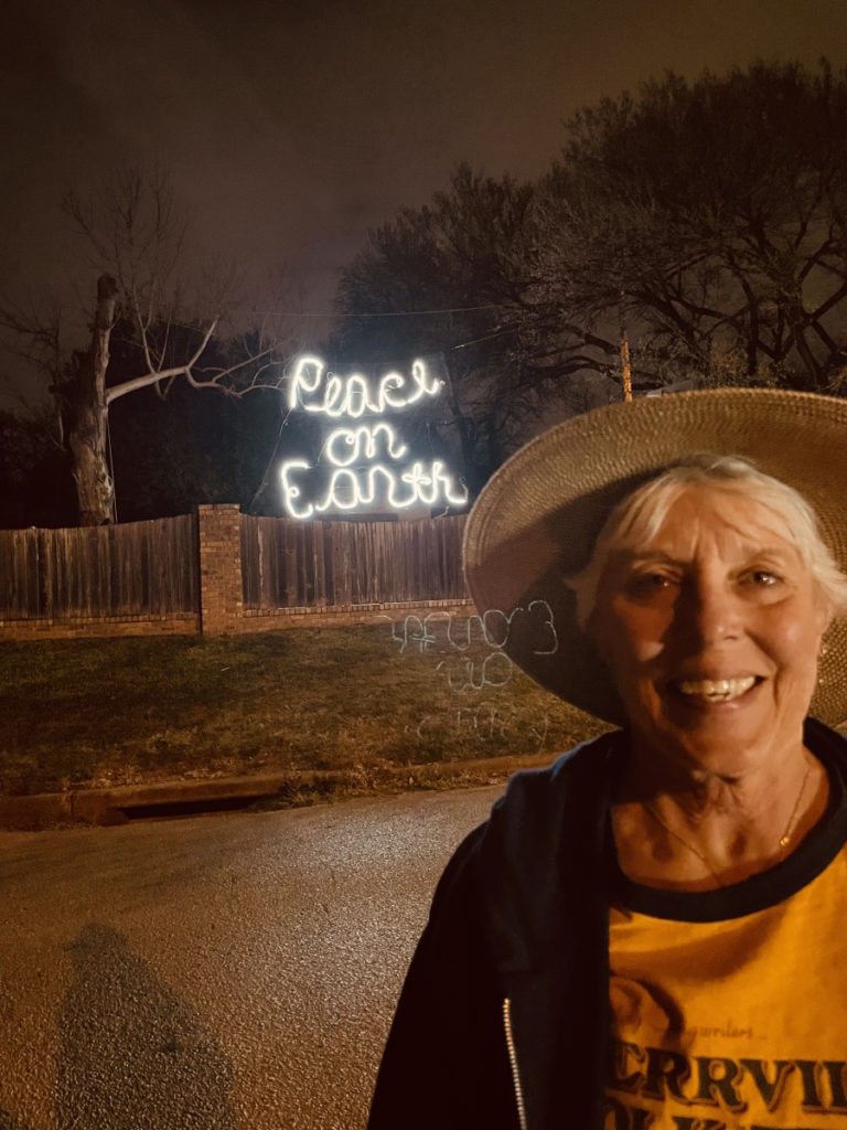 Vickie D. with peace on earth sign