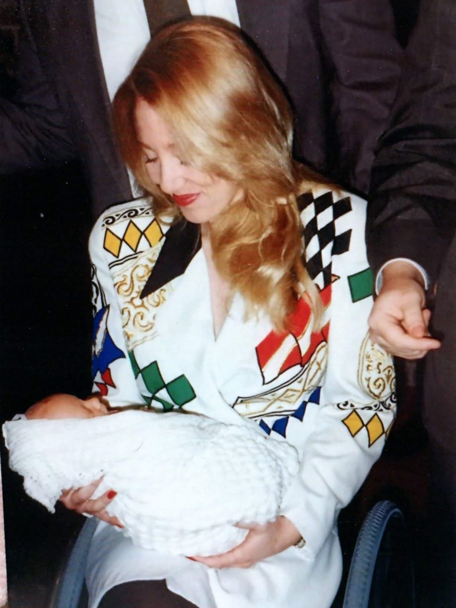 Karen R. in wheelchair holding baby