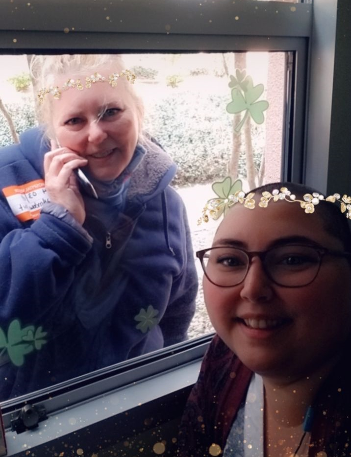 Tatijane W. with mom through window
