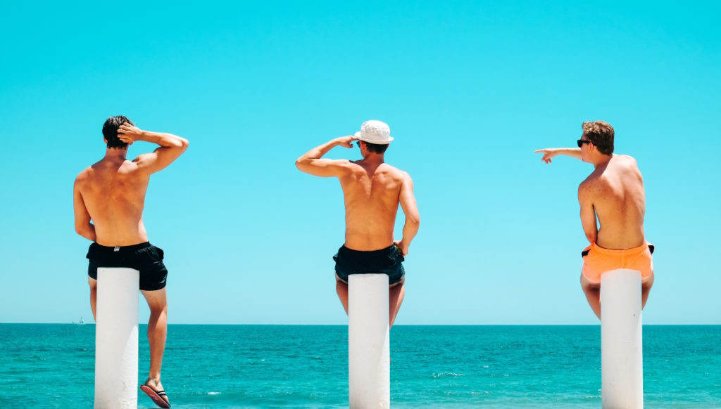 group of male friends at the beach